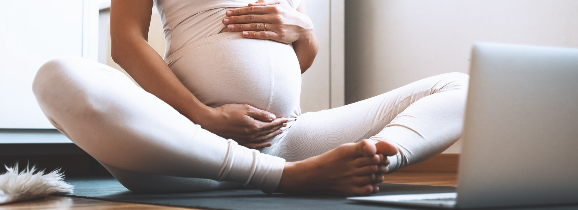 A pregnant person sitting on the floor