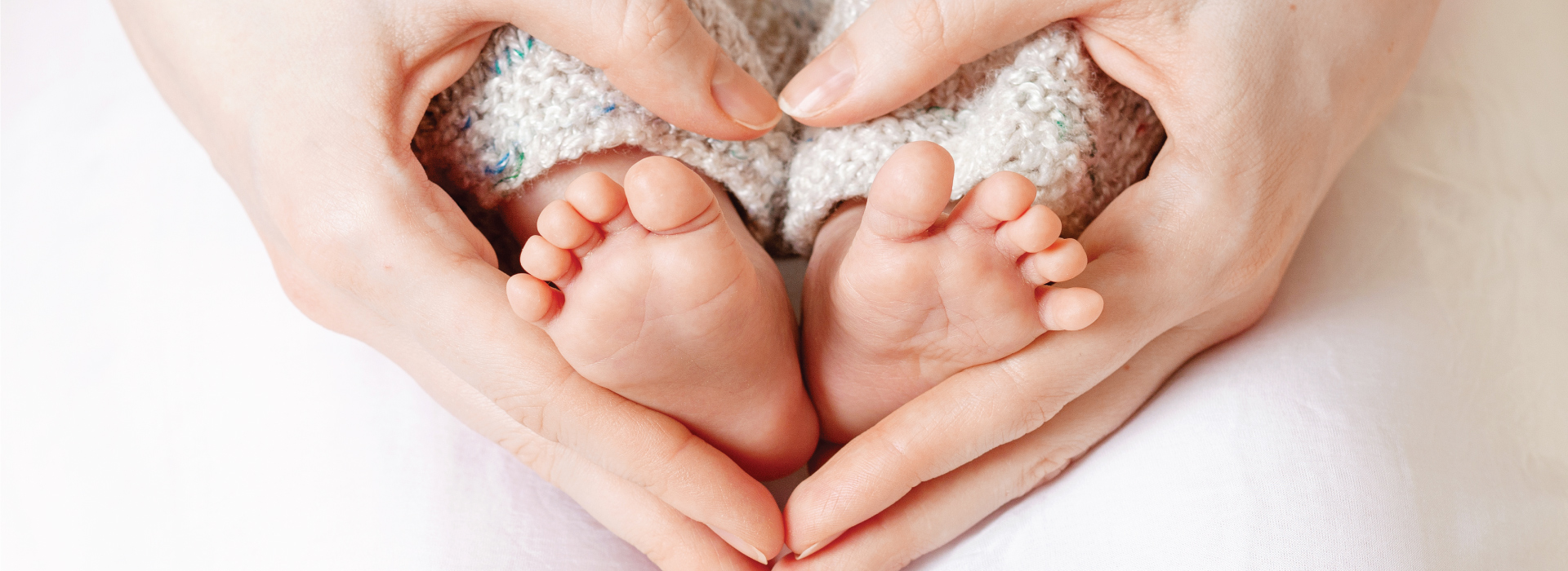 A baby feet in a person's hands