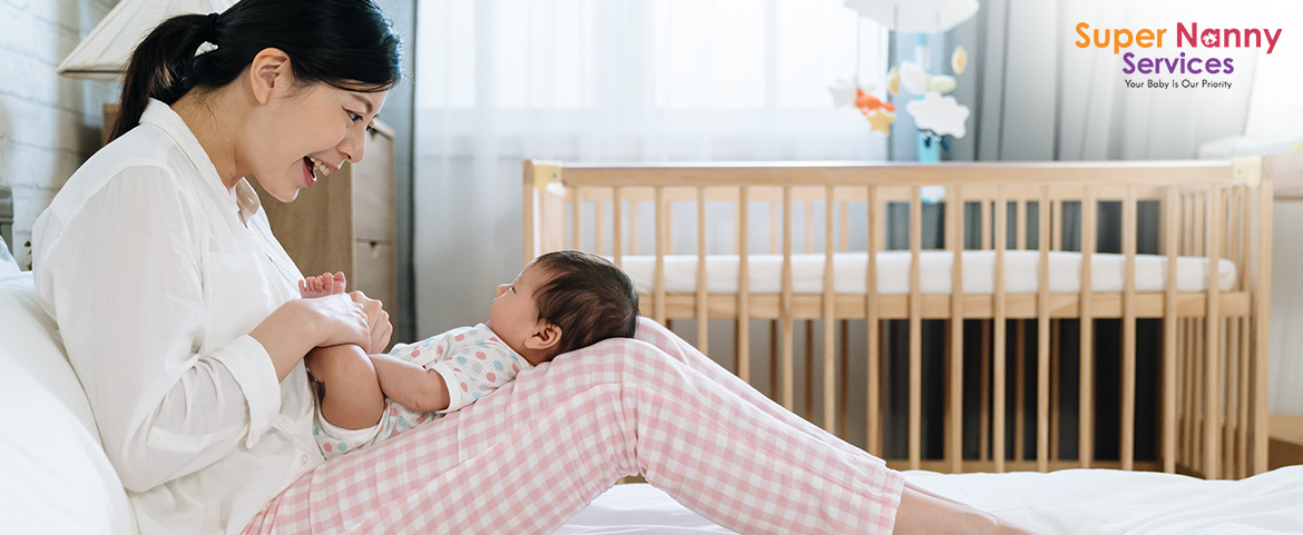 Image of Mother playing with her infant