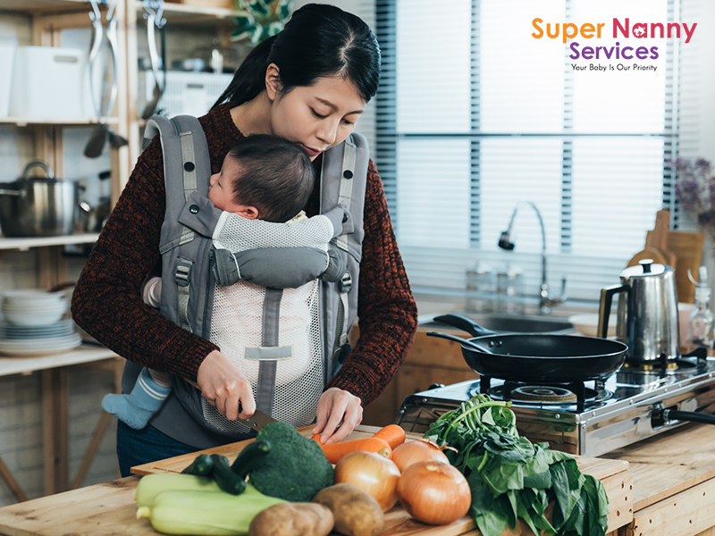 A mother taking care of her child while cooking