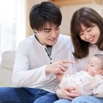 Husband & Wife playing with their infant