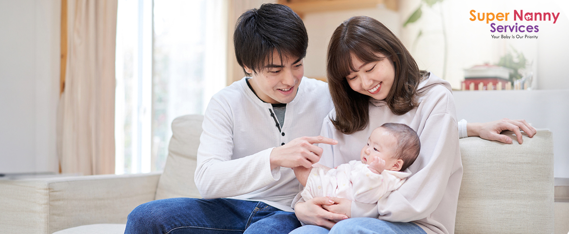 Husband & Wife playing with their infant