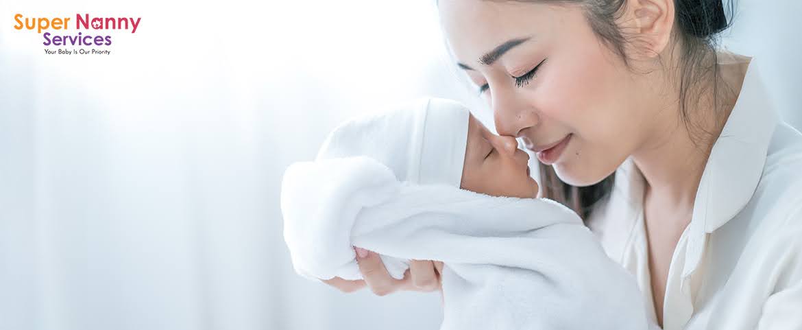 Mother touching nose with her baby