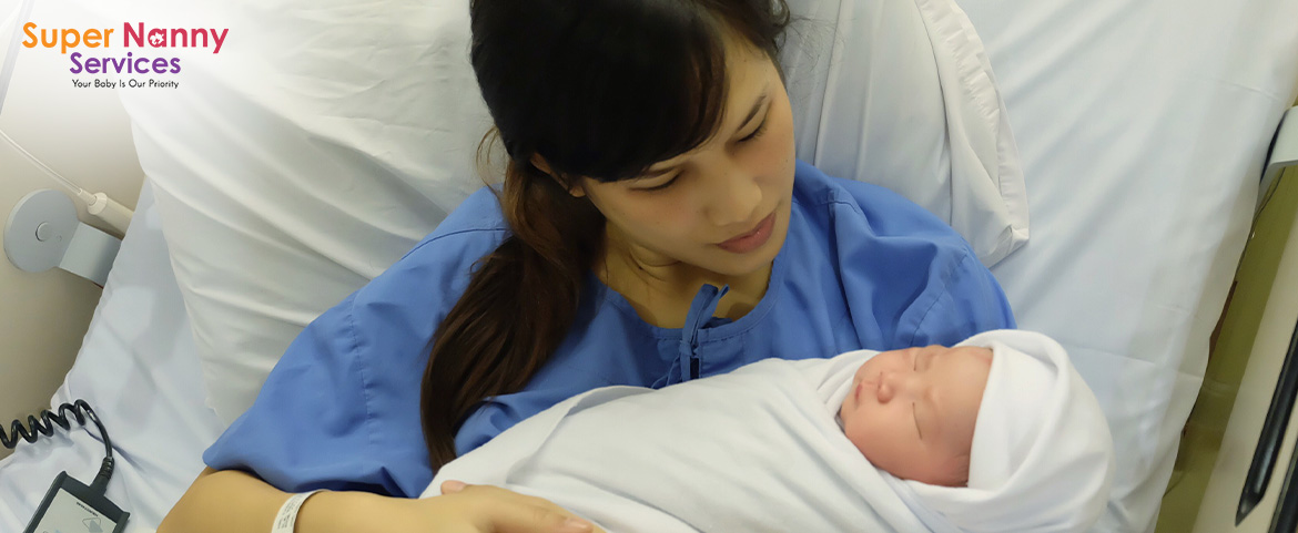 A new mother cuddling her newborn baby in a hospital bed.