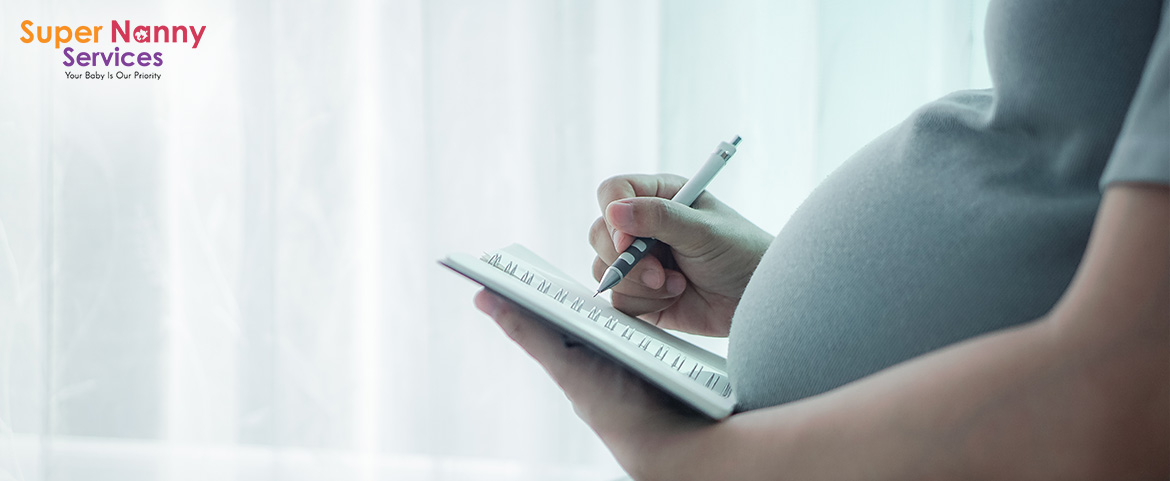 Pregnant woman writing notes for a prenatal workshop.