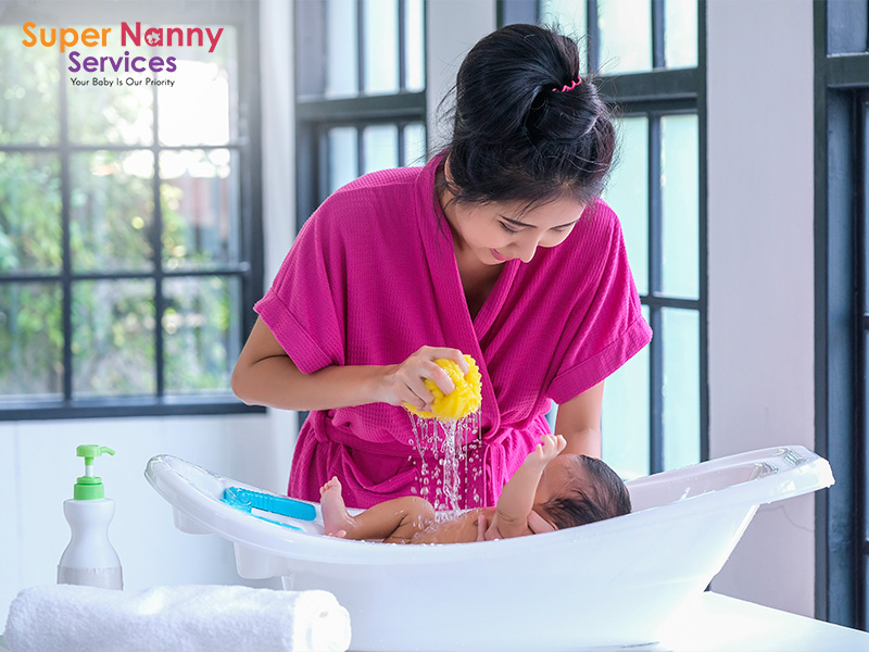 Woman practicing newborn baby bathing techniques.